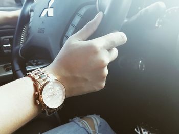 Close-up of woman hand in car