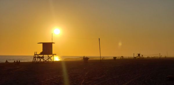 Scenic view of beach against sky during sunset