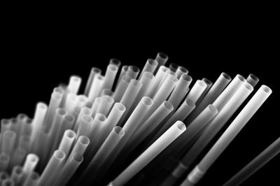 Close-up of colored pencils over black background