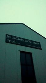 Low angle view of road sign against building