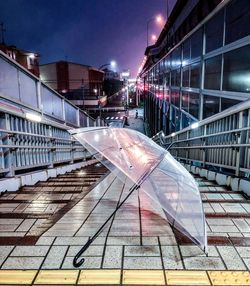 Umbrella on staircase in city at night