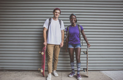 Full length portrait of a teenage girl standing outdoors