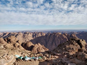 Panoramic view of rocks on shore against sky