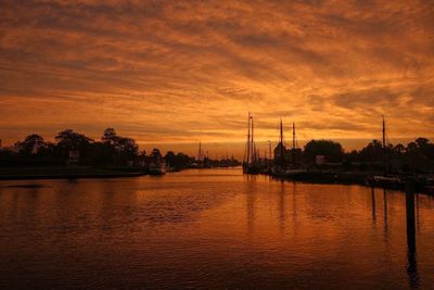 Scenic view of river against sky during sunset