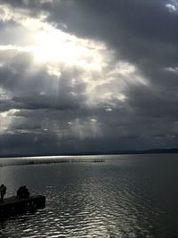 Scenic view of sea against storm clouds