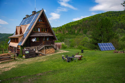 Panoramic view of traditional windmill on field against sky