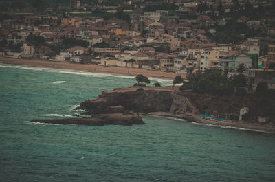 Scenic view of sea and buildings in town