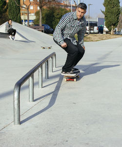 Man skateboarding on footpath in park