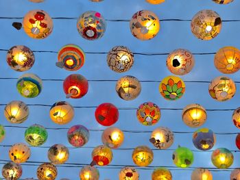 Low angle view of illuminated lanterns hanging on ceiling