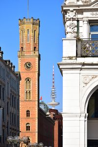 Low angle view of clock tower in city