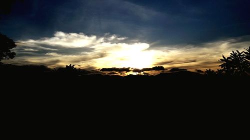 Silhouette landscape against sky at sunset