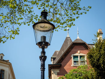 Low angle view of street light against building