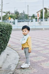 Portrait of boy walking on street