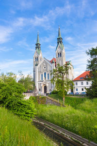 View of trees and building against sky