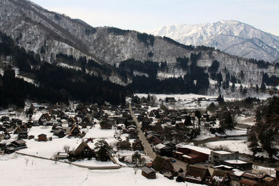 High angle view of trees and snowcapped mountains