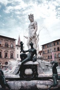 Low angle view of statues against sky