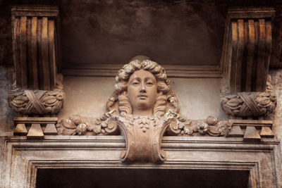 Statue of buddha against building