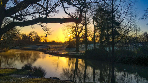 Scenic view of lake against sky during sunset