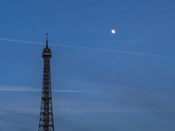 Low angle view of eiffel tower against blue sky