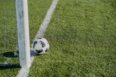 Football soccer goals and ball on clean empty green field