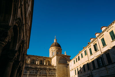 Low angle view of building against clear blue sky