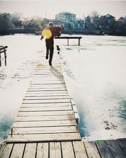 Man walking on pier
