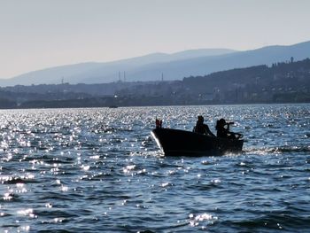 Boat sailing in sea against sky