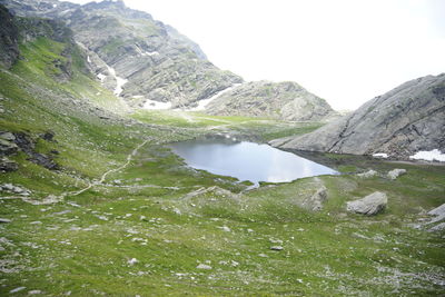 Scenic view of lake amidst mountains against sky