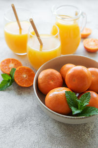 Glasses of fresh orange tangerine juice with fresh fruits