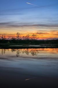 Scenic view of lake against sky during sunset