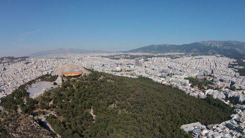 High angle view of cityscape against clear blue sky