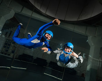 Low angle view of boy jumping in tunnel