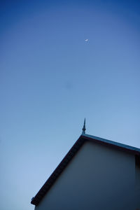 Low angle view of house against clear blue sky