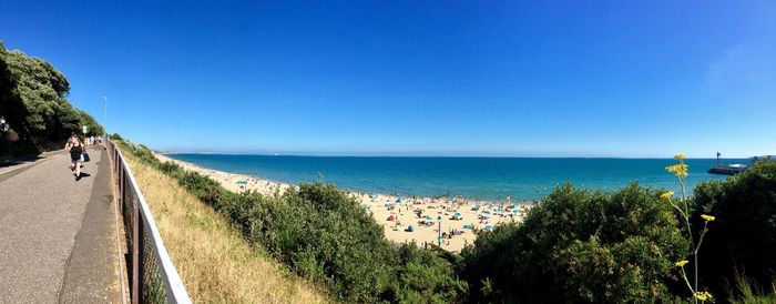 Panoramic view of beach against blue sky