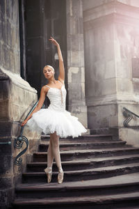 Full length of woman dancing on steps