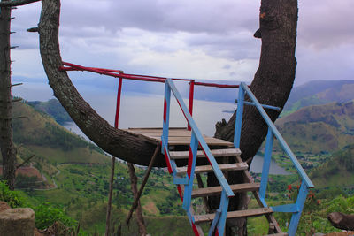 Lifeguard hut on land against sky
