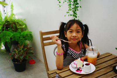 Happy girl sitting on table