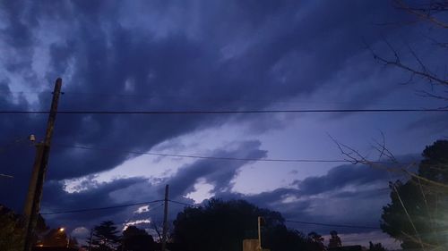 Low angle view of silhouette trees against sky at dusk