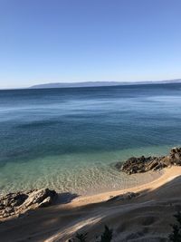 Scenic view of sea against clear blue sky