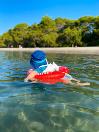 Rear view of boy in swimming pool