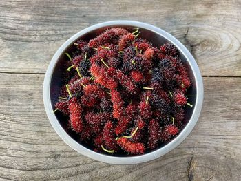 High angle view of strawberries in bowl on table