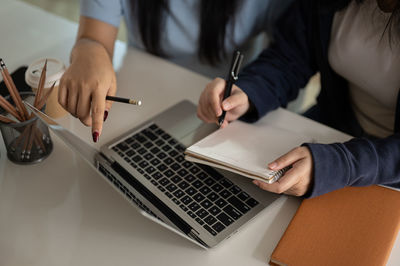 Midsection of man using laptop