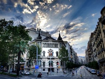 Statue in city against sky