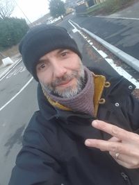 Portrait of smiling man in park during winter