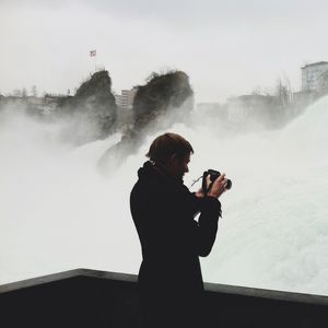 Woman photographing through camera