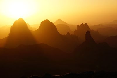 Scenic view of silhouette mountains against sky during sunset