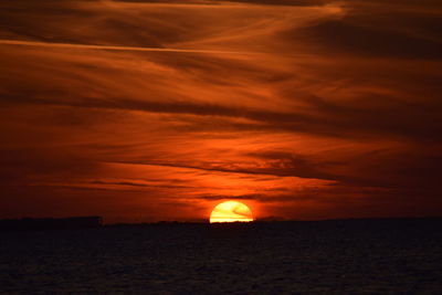 Scenic view of silhouette landscape against orange sky