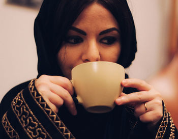 Portrait of woman drinking coffee