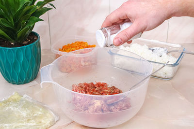 Cropped hand of person preparing food