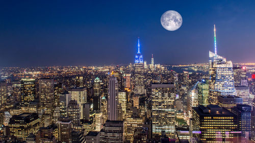 Aerial view of city lit up at night